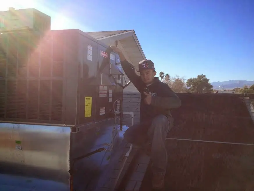 HVAC technician performing AC Tune-Up on a rooftop unit in Wrightsboro